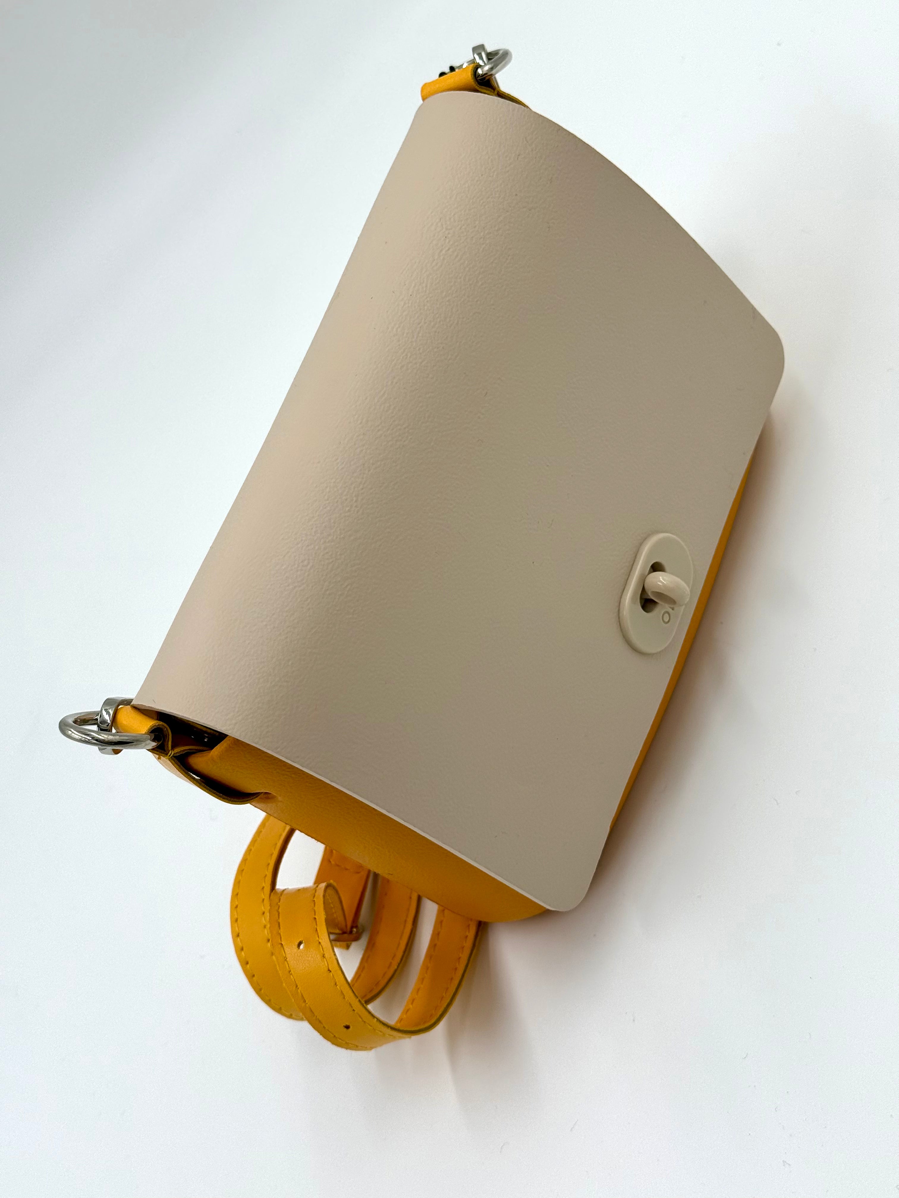 O bag Pocket mini bag – yellow body, off-white lid, twist lock, yellow strap